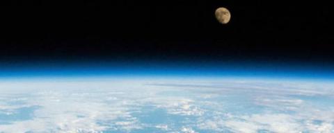 NASA photo showing the moon above blue earth.
