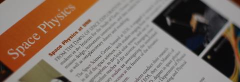 A close-up of text about space physics with colorful photos flanking each side. 