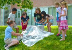 students and teacher conducting an experiment outdoors