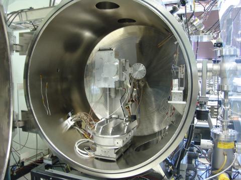 Silver, round HOPE instrument in calibration chamber.