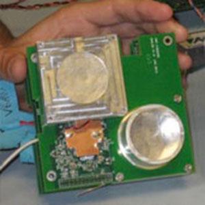 Hand holding a green single engineering unit sensor assembly