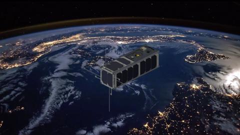 Rendering of a cube satellite over Earth.
