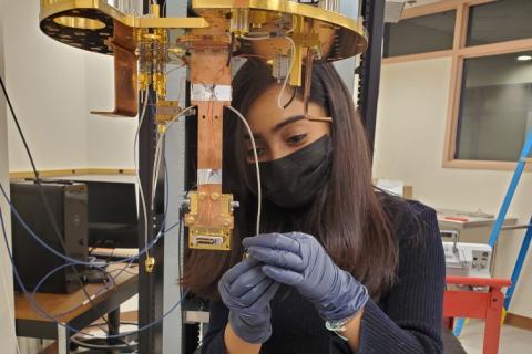 Adrika Dasgupta, a Ph.D. student in physics, installs a transition-edge sensor (TES) in a dilution refrigerator located in Morse Hall.