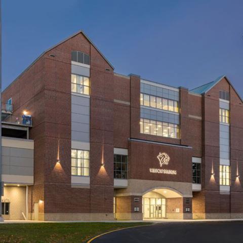 Photo of Wildcat Stadium Victory Club from the front at night.