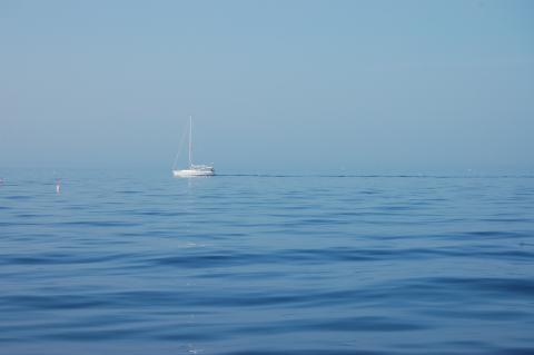 blue ocean with sailboat