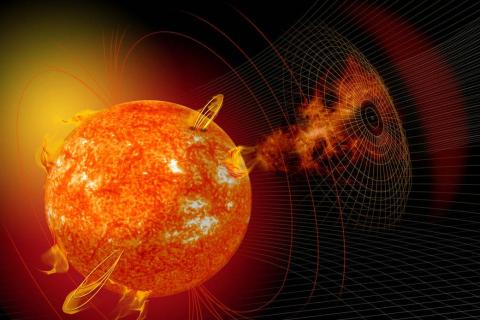 An artist's rendering of the sun, with solar eruptions coming off the surface and a grid drawn nearby.