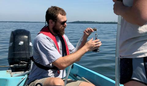 James Lazarcik collecting a water column sample for routine analyses with an undergraduate helper. James collecting a water column sample with an undergraduate helper for routine analyses.