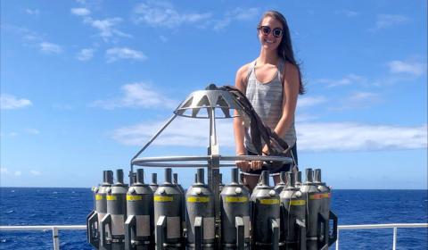 Sarah Benson out at sea on the R/V Kilo Moana with a CTD Rosette sampler.