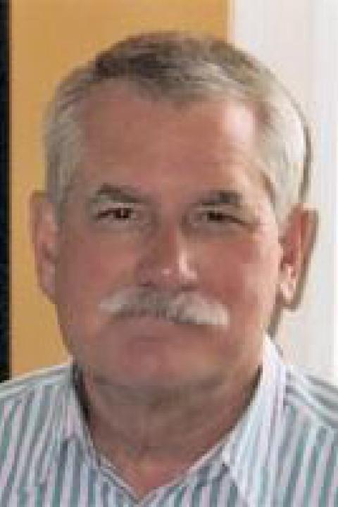 A headshot of William Ellison